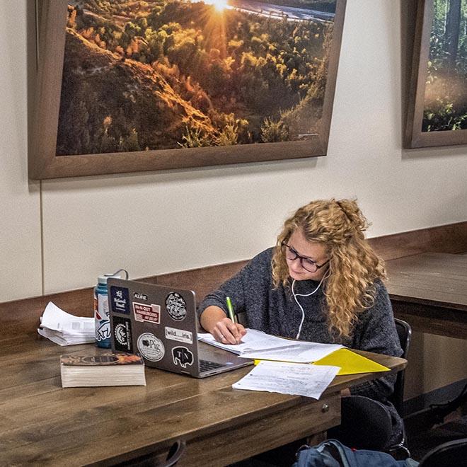 A University of Mary student studying in the lower level of the Crow’s Nest Campus Restaurant.
