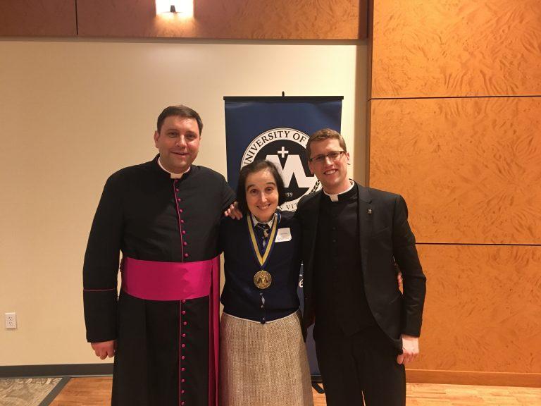 President Monsignor James Shea, left, Dr. Emanuela Molla, center, and Father Robert Shea, right.