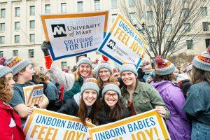 Students at the ND March for Life holding signs