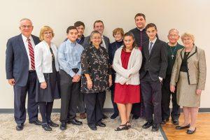 Patrick Reilly, poses with family, friends and University Mary President Monsignor James Shea. 