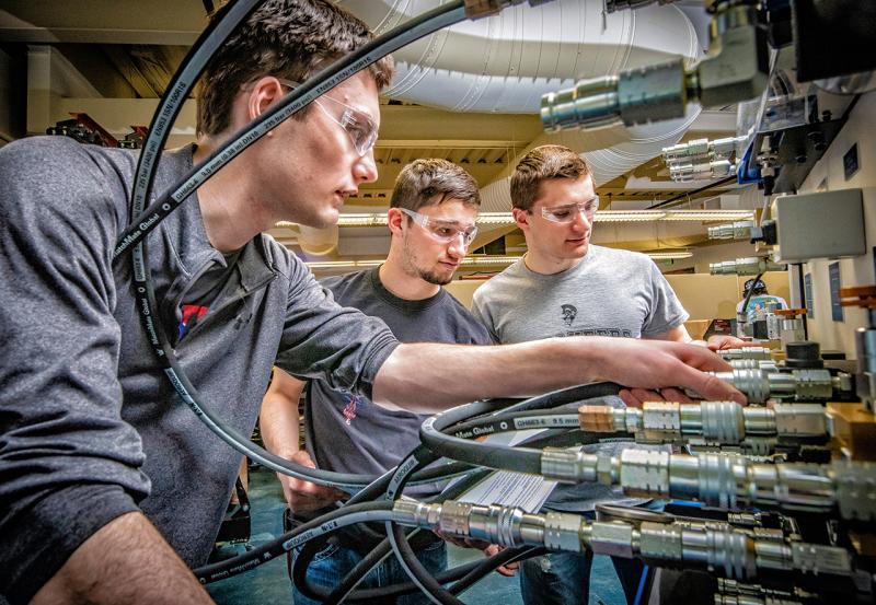 Students working with Hydraulic Lift Test Stand