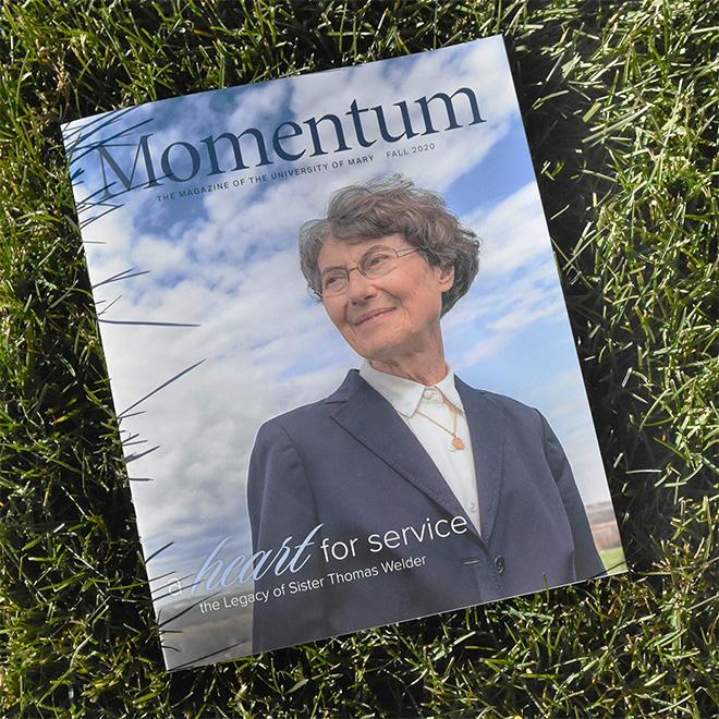 A momentum magazine staged on grass