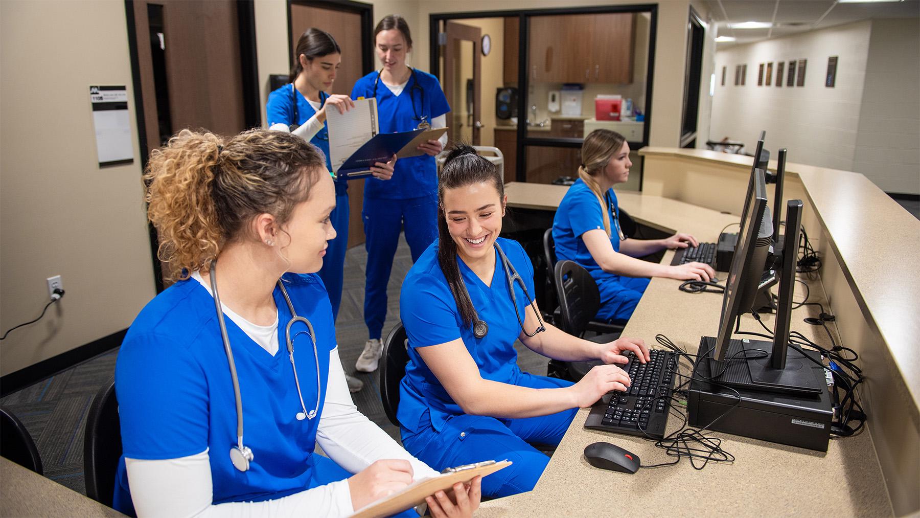 Nursing students working in the sim labs