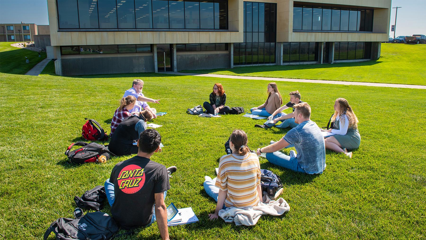 Students with Dr. Collins having class on the shire