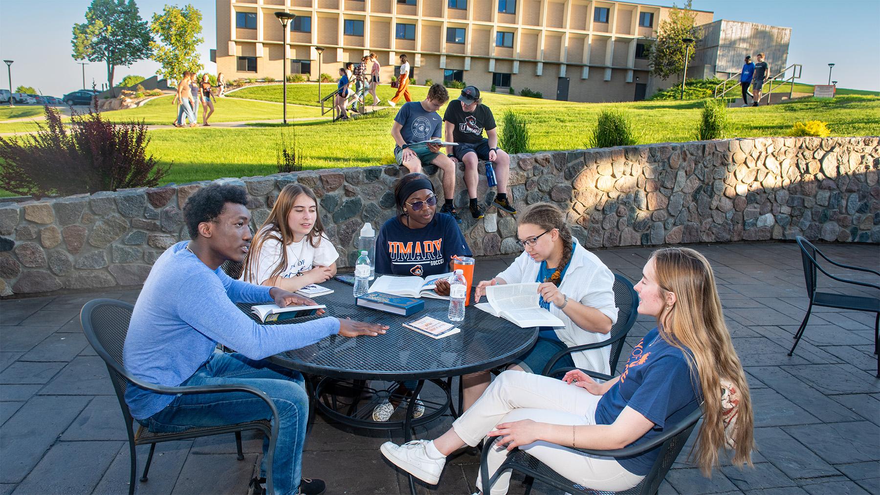 Students studying outside on the patio