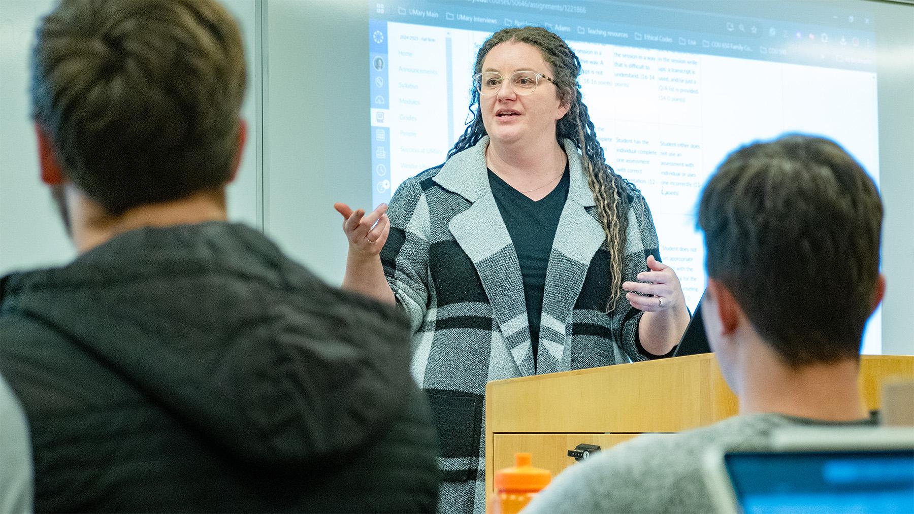 Teacher giving a lecture in front of her students