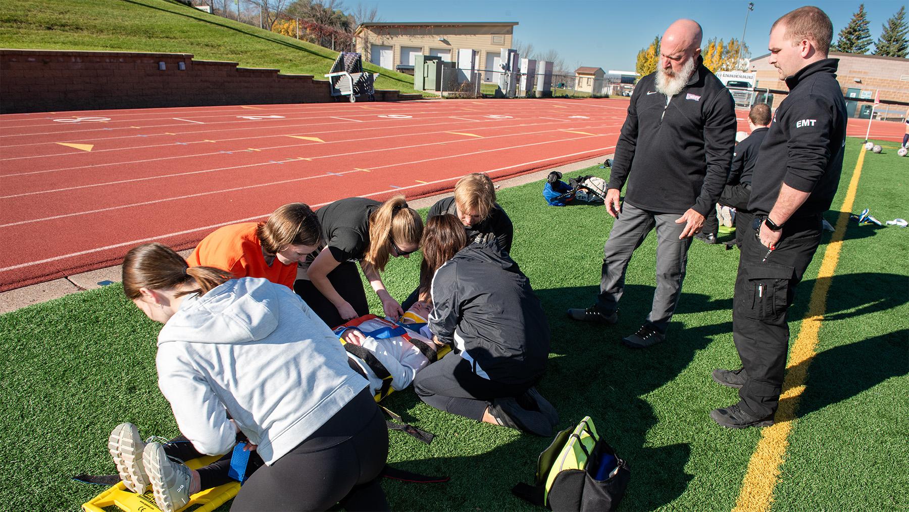 Athletic Training Students practicing on the field