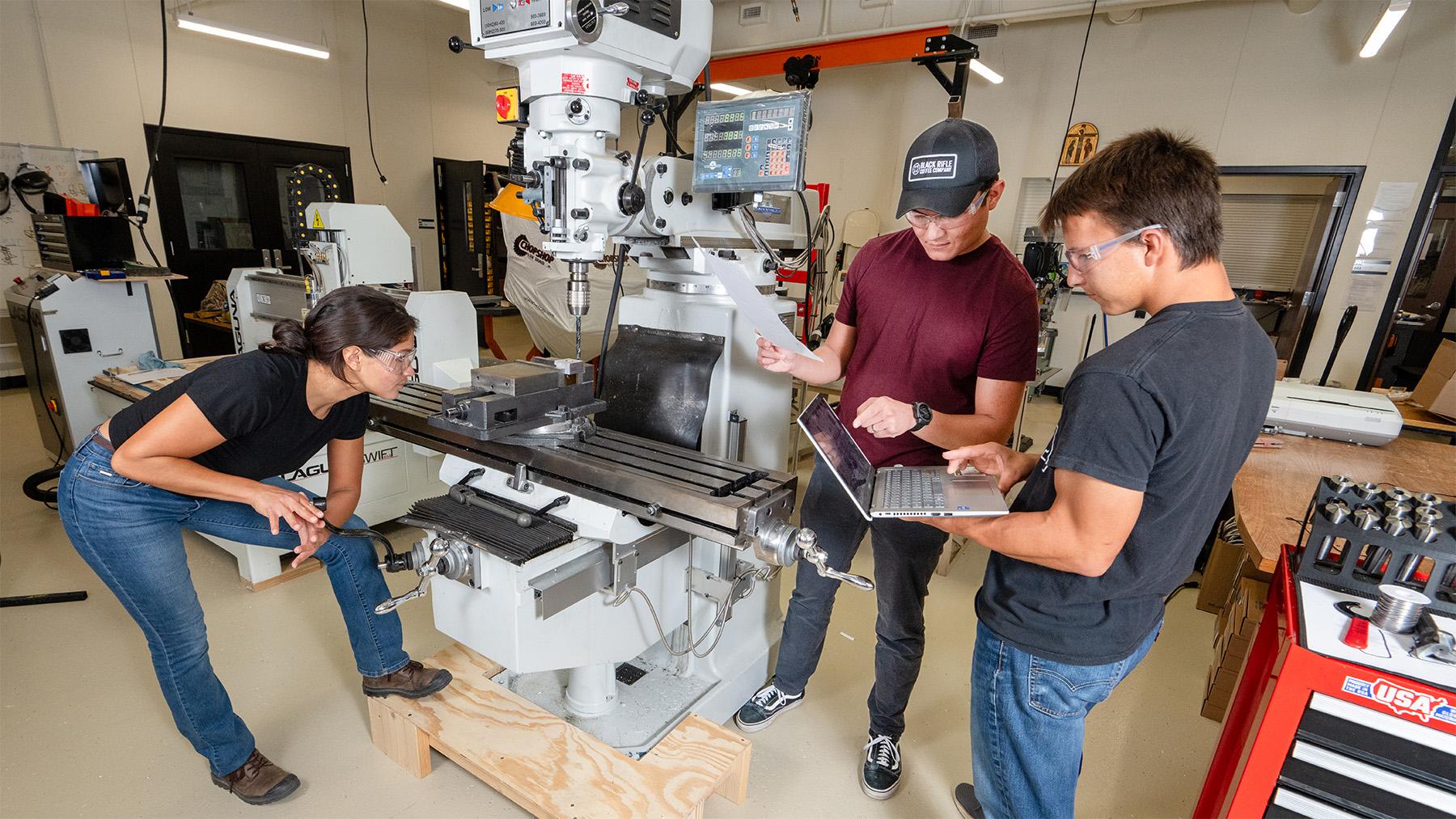 Students operating the machines in the engineering labs.