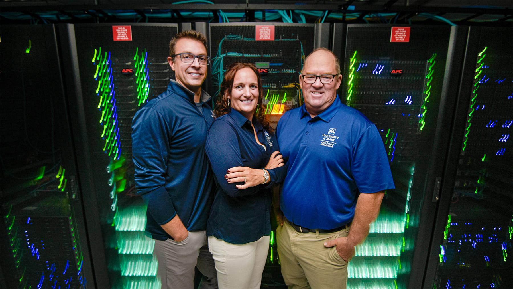 faculty standing in front of the computer servers